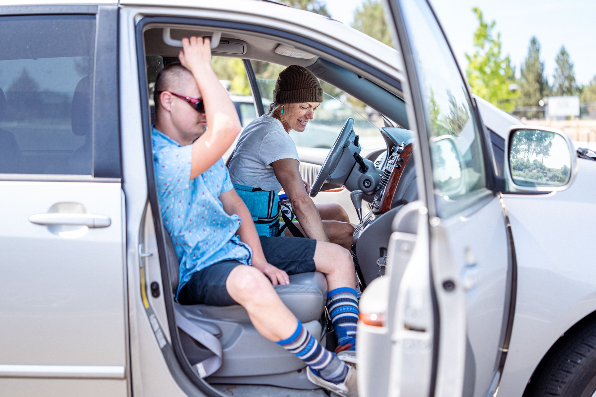 Woman and teenage son in car after park outing